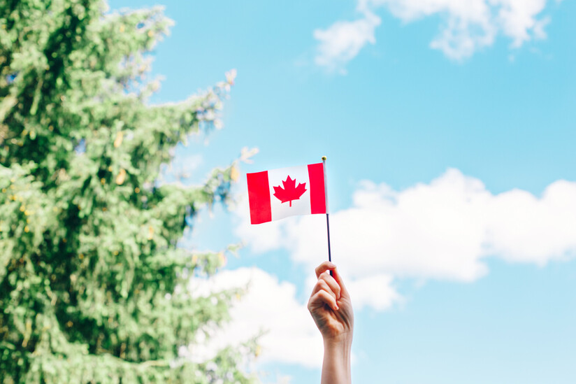 Canada flag on blue sky background